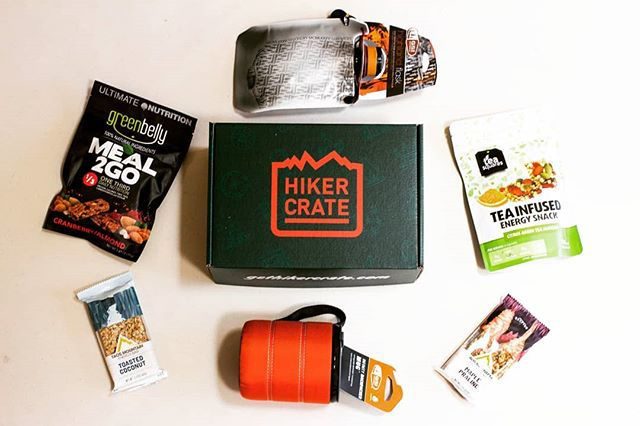 The Hiker Crate box surrounded with hiking food and gear.