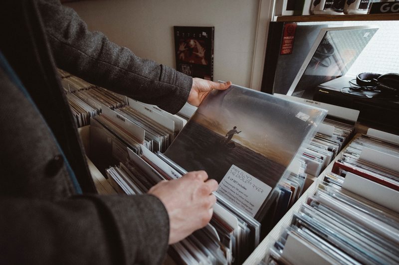 man looking through vinyl records in shop