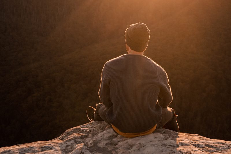 man sitting alone thinking