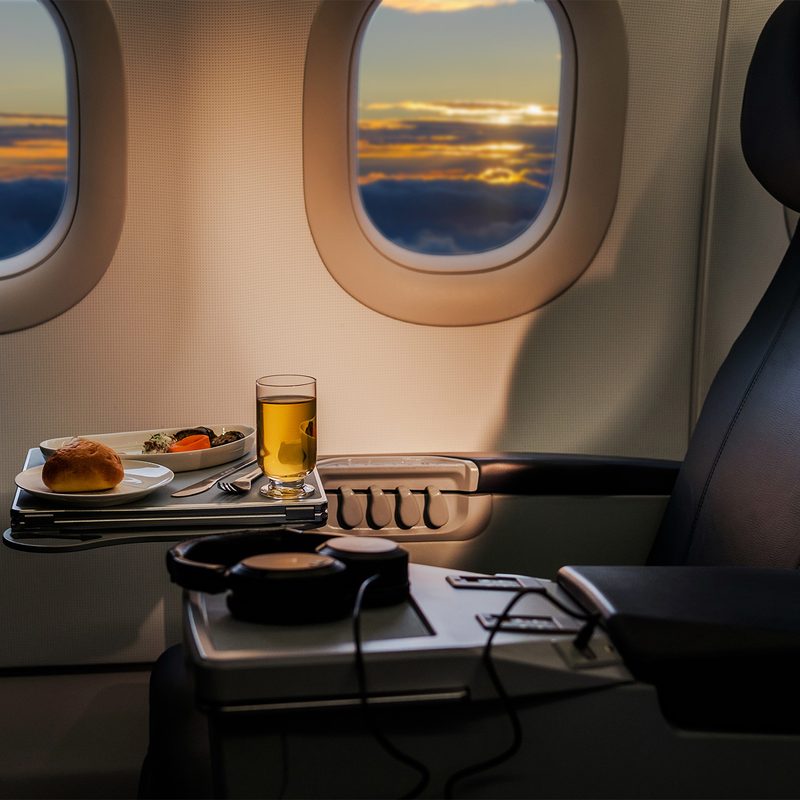 A meal with drink on a plane