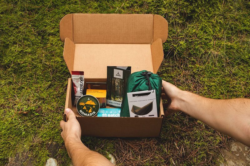 The Nomadik subscription box on grass.