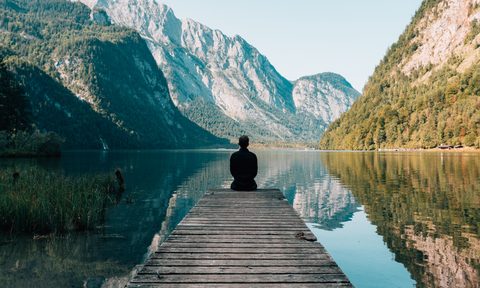 Person looking at the mountains and water