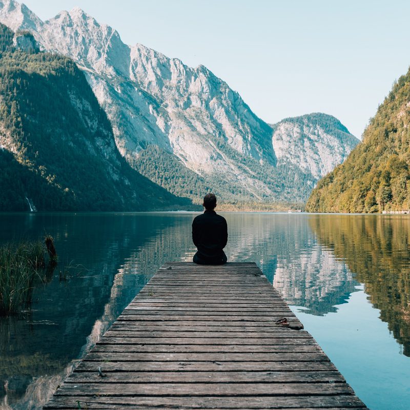Person looking at the mountains and water