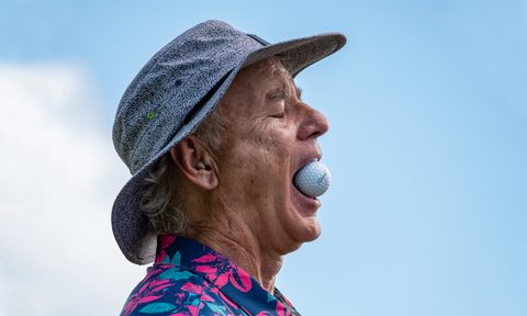 bill murray with a golf ball in mouth