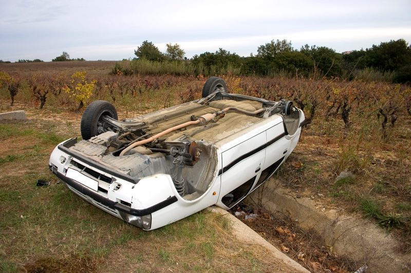 car flipped over in a vineyard
