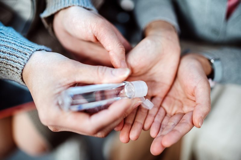 Family using hand sanitizer