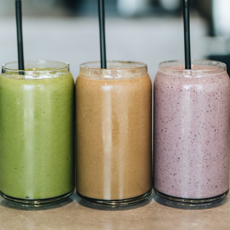 Three smoothies on a countertop