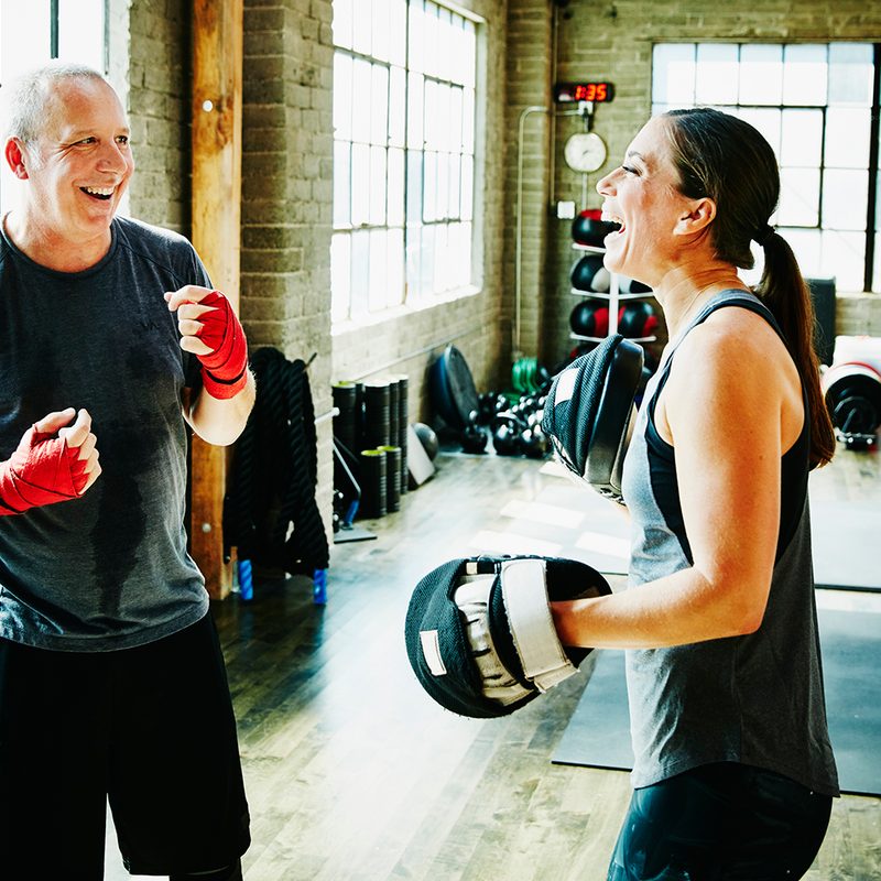 Middle-aged man in a fitness fighting class.