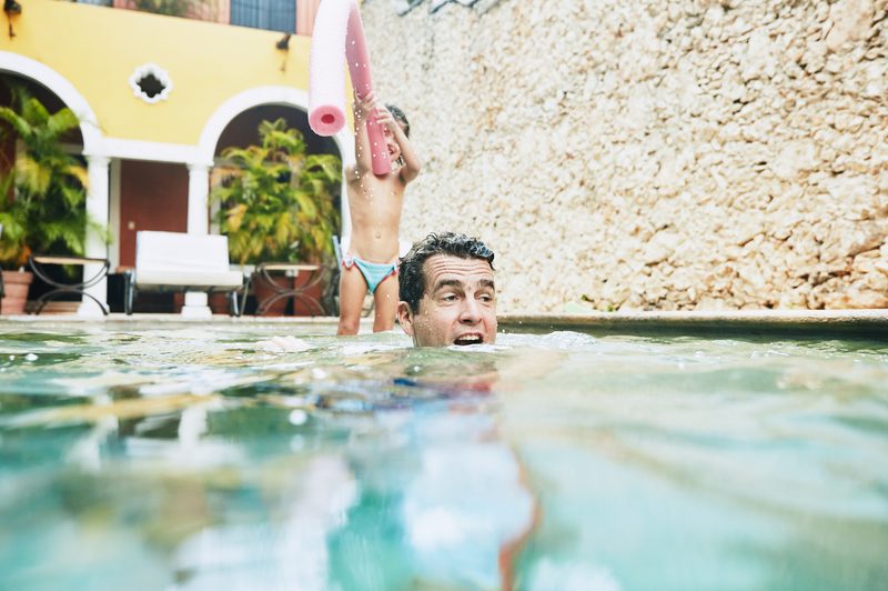 parents and children at a pool on vacation