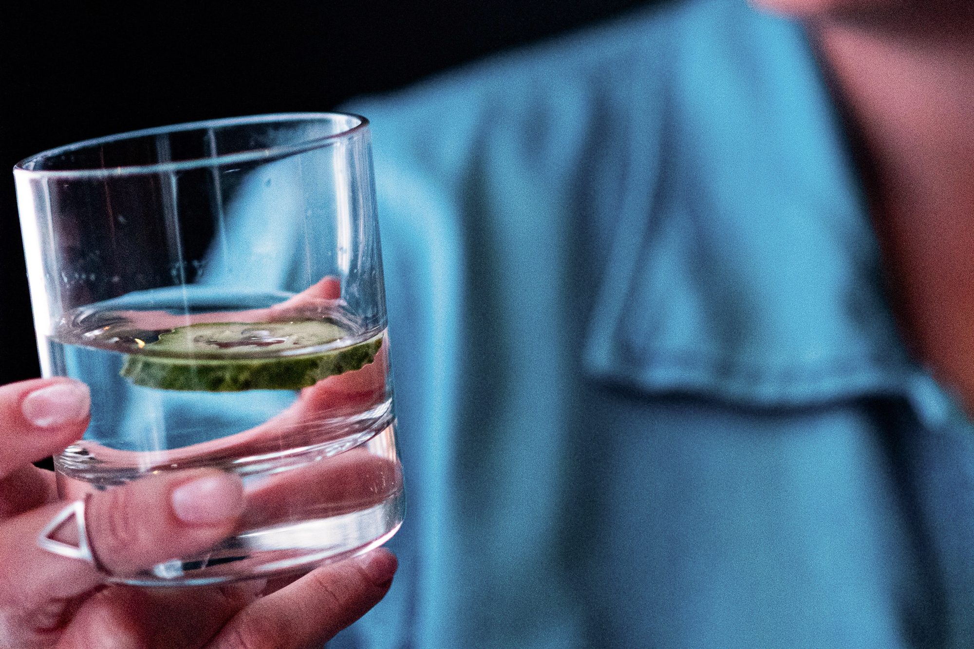 person drinking cucumber water