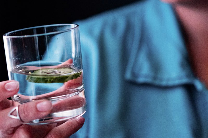 person drinking cucumber water