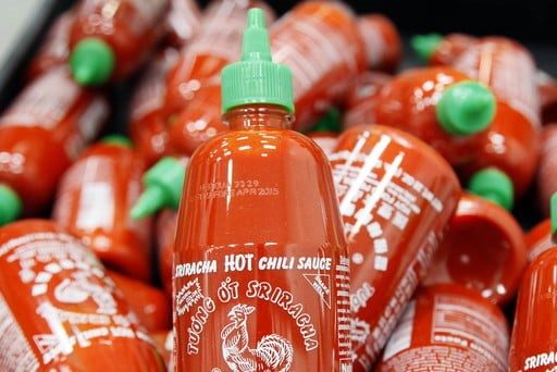Containers of Sriracha hot sauce
