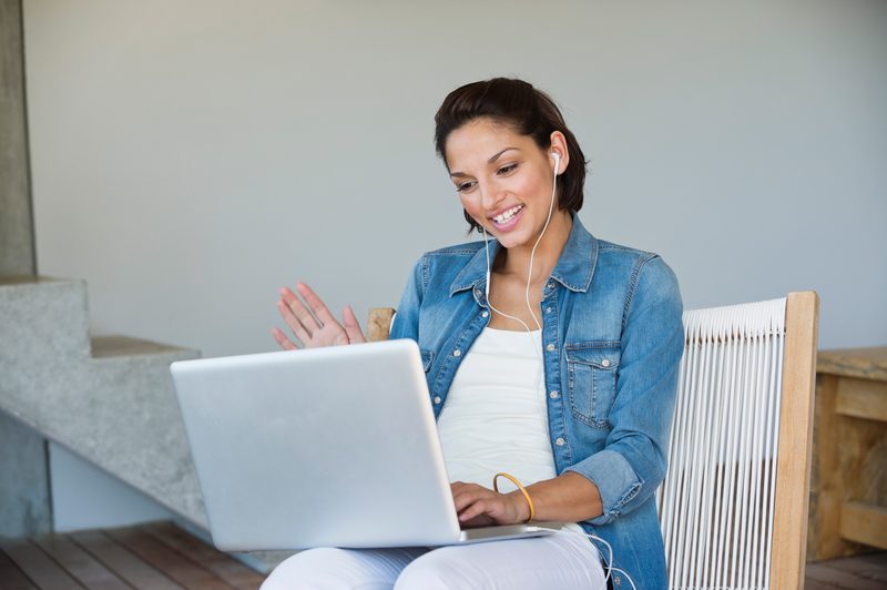 woman listening on laptop