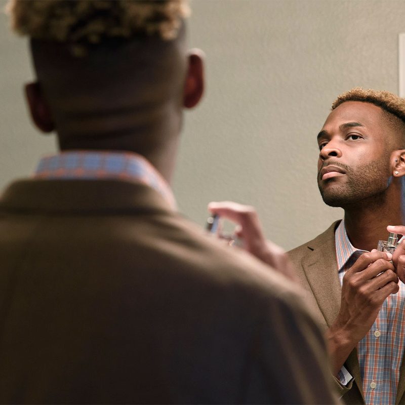 Man putting on cologne