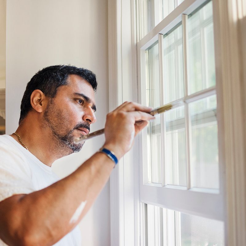 man looking out the window. diy home projects window sill painting.