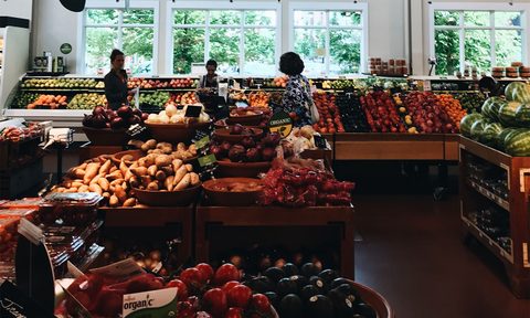 People at a grocery store produce section