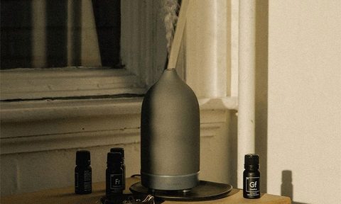 A diffuser on a table in a room.