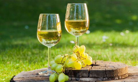 Sauvignon blanc white wine on a table with grapes