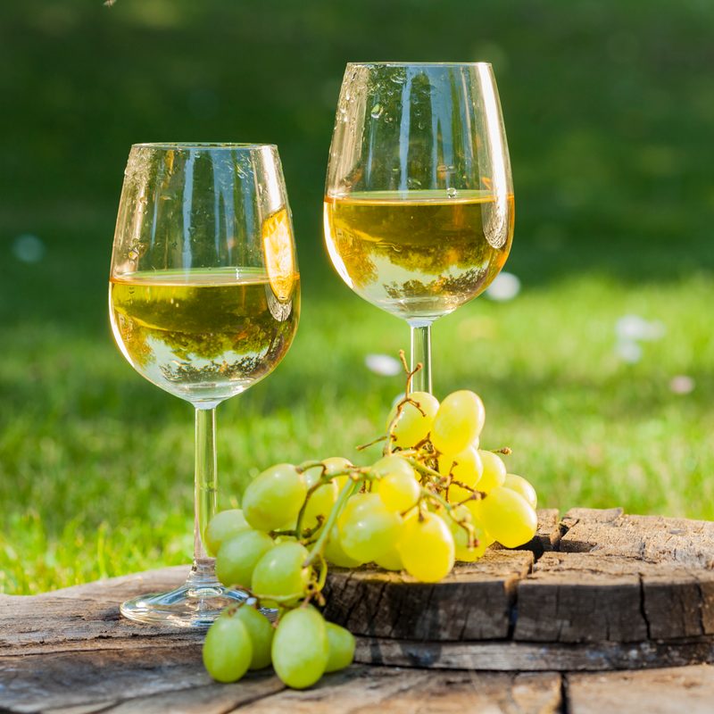 Sauvignon blanc white wine on a table with grapes