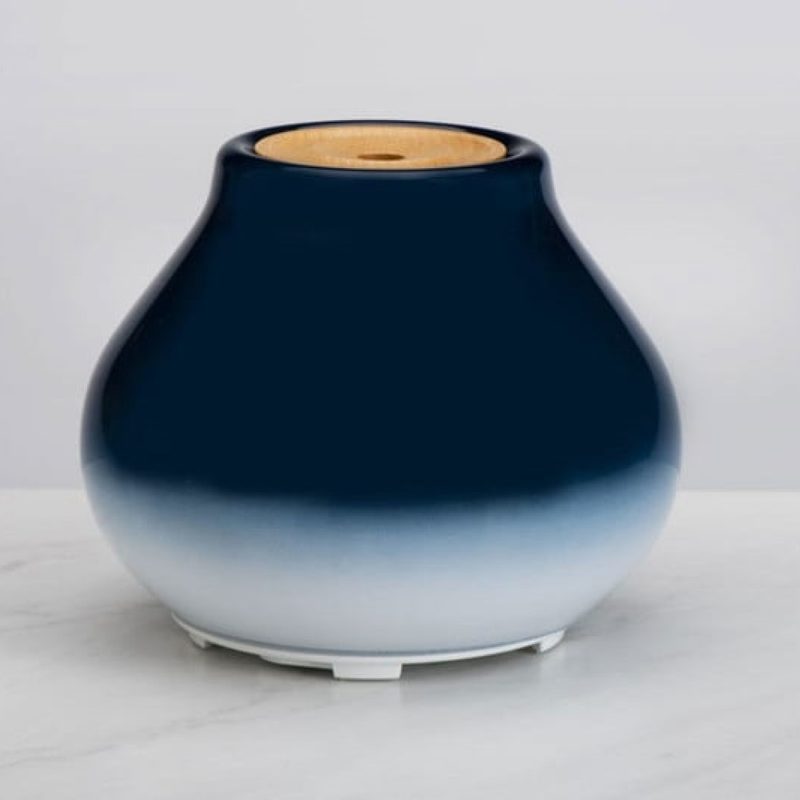 A blue Ellia Imagine Cordless Ultrasonic Aroma Diffuser on a white table.