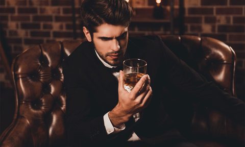 man drinking whiskey