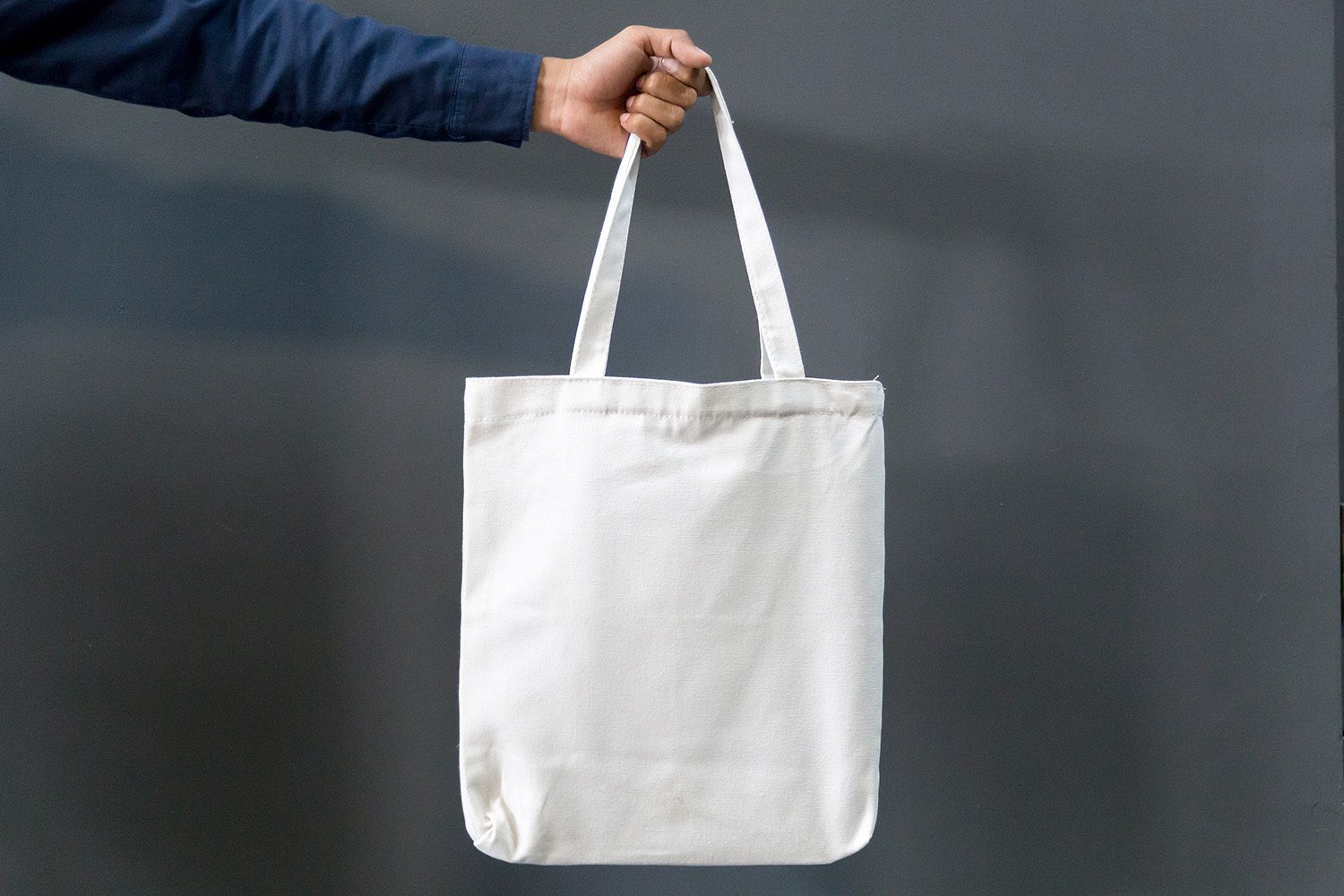 man holding tote bag