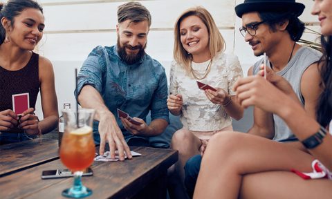 Friends playing drinking card game