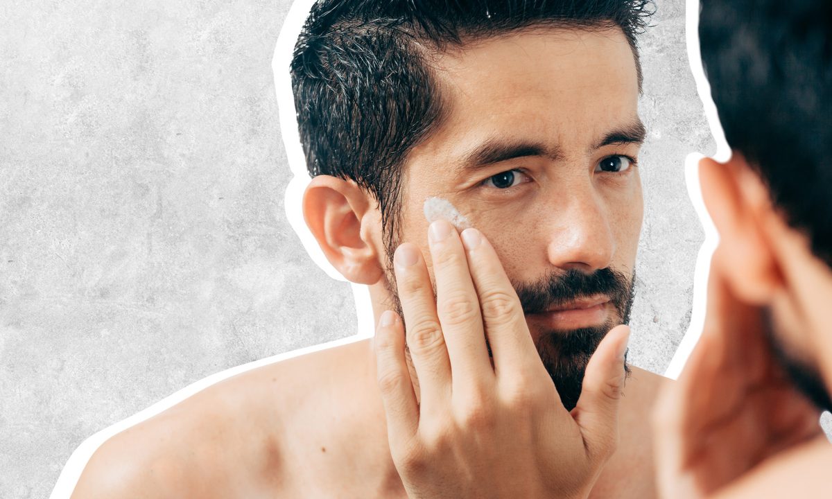 Man using face moisturizer