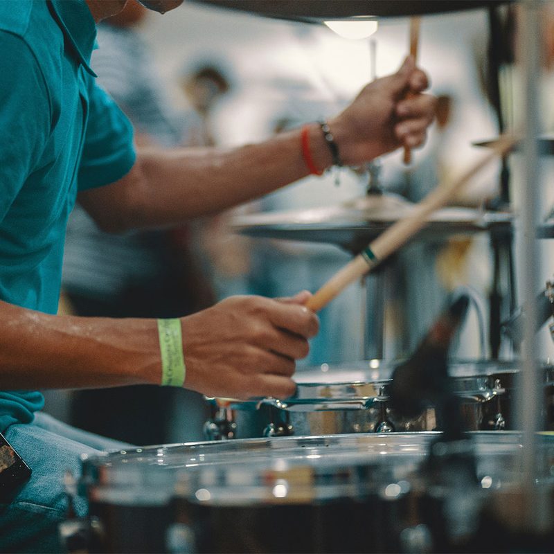 Man playing drums with drumsticks.
