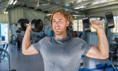 Man doing dumbbell overhead press