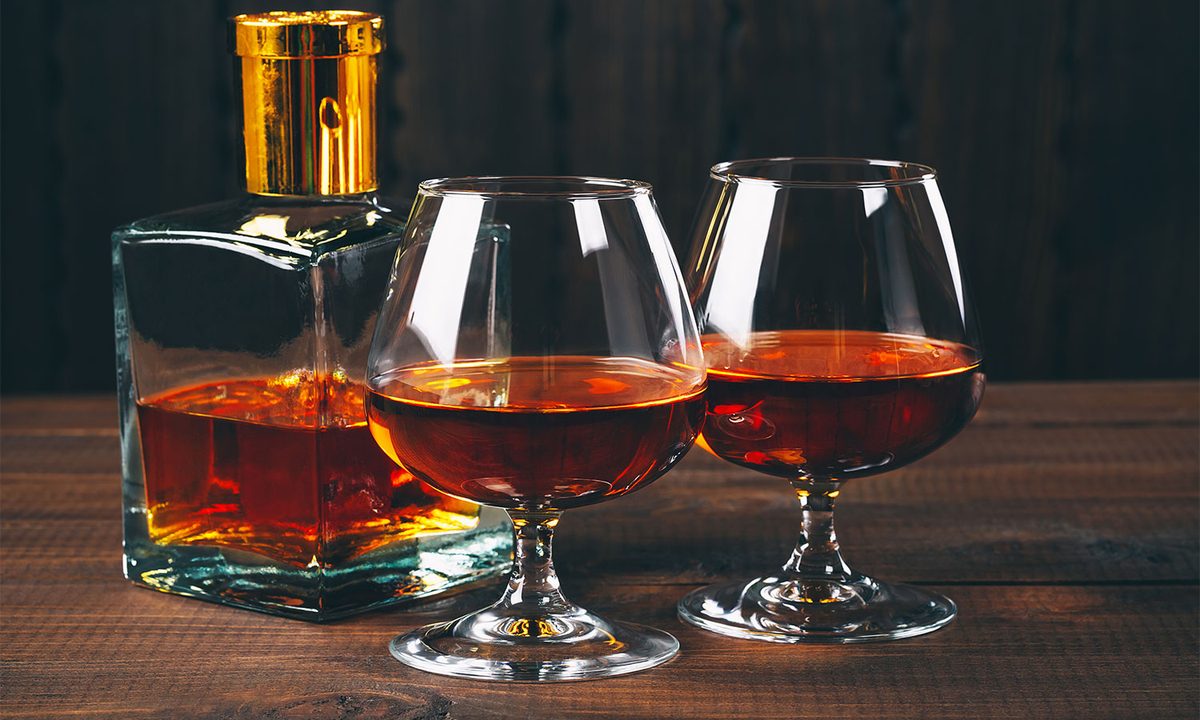 Glasses of brandy or cognac on the wooden table