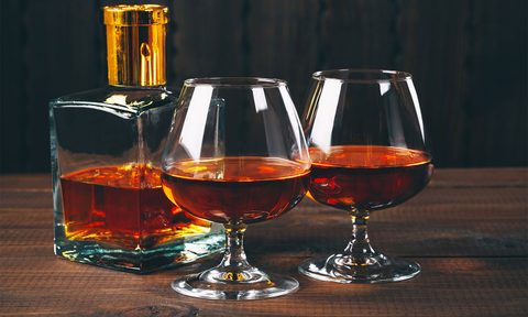 Glasses of brandy or cognac on the wooden table