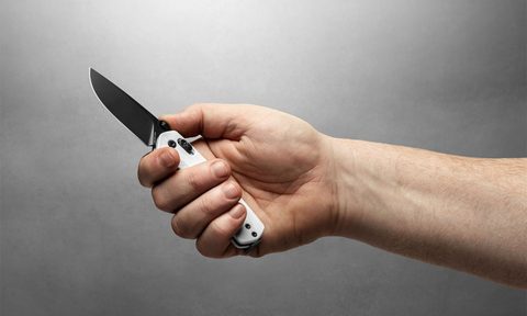Hand holding a flipper knife