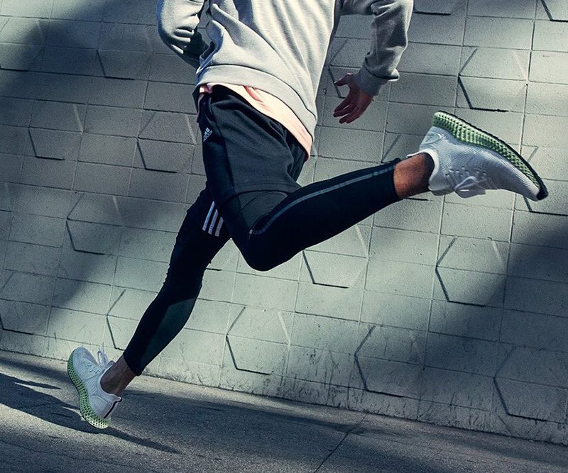 A man running with his pair of athletic sneakers.
