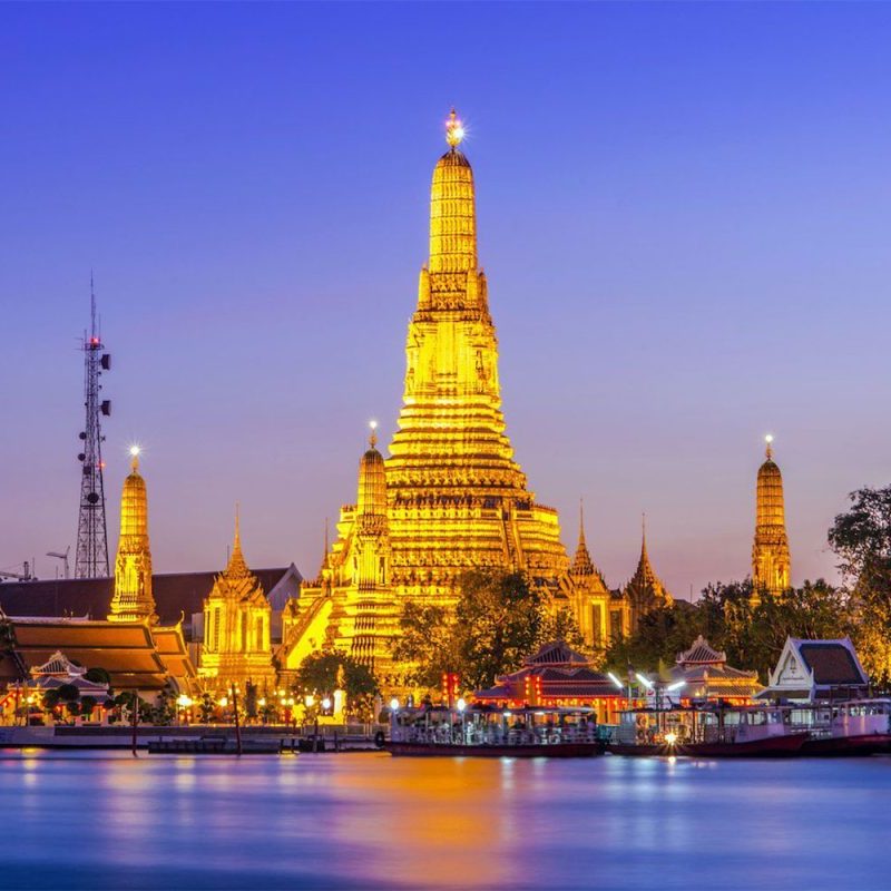 Skyline view of Bangkok Thailand at night with the buildings lit up.