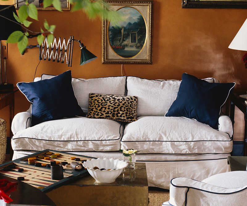 A painting collection on a living room wall.