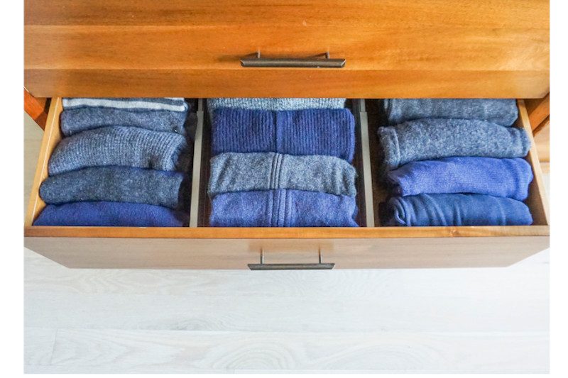 Open drawer with sweaters
