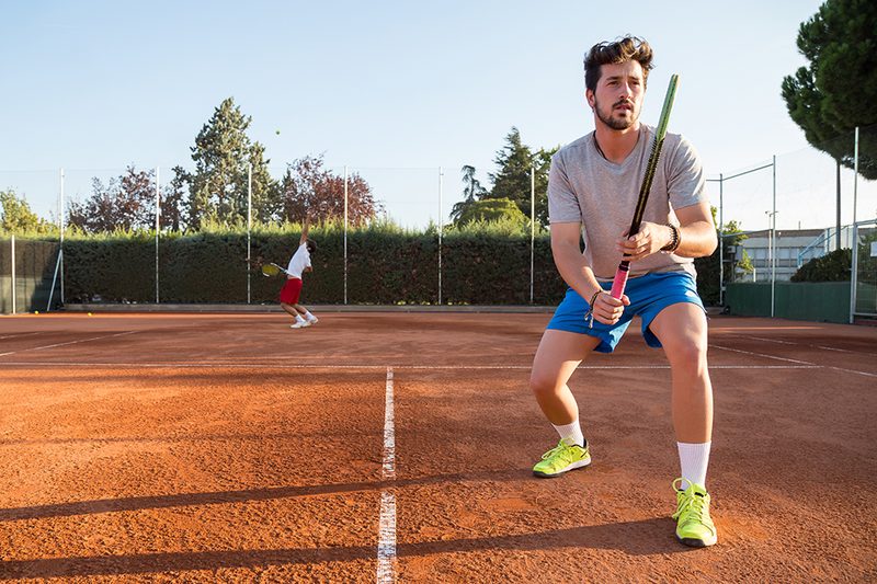 Young Men Playing Tennis