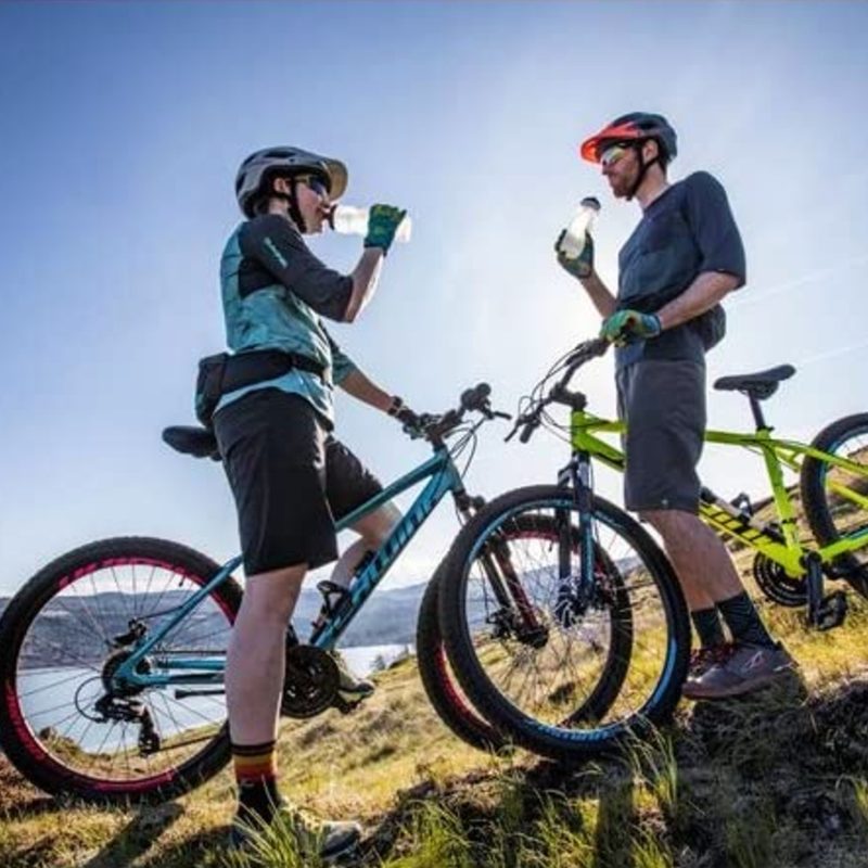Man and woman taking a break while riding their Schwinn mountain bikes