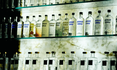 Liquor bottles on a bar shelf