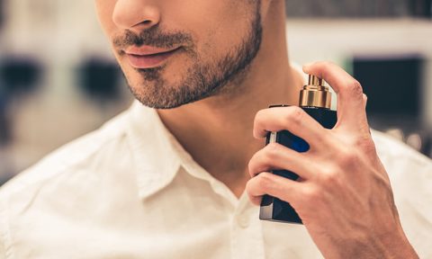 Man spraying on cologne