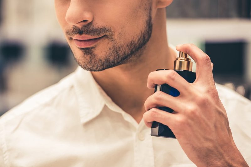 Man spraying on cologne