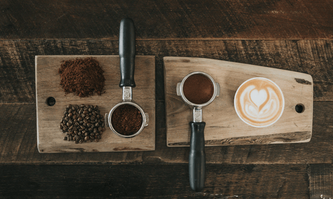 Coffee beans, ground coffee, and a cup of coffee