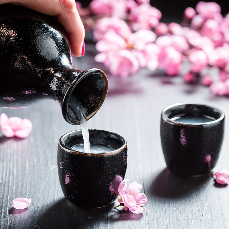 Female hand pouring sake