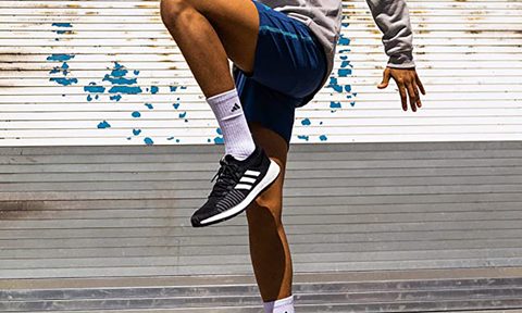A man wearing Adidas shoes and socks.