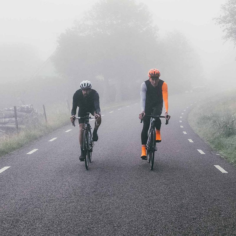Two people riding bikes next to each other
