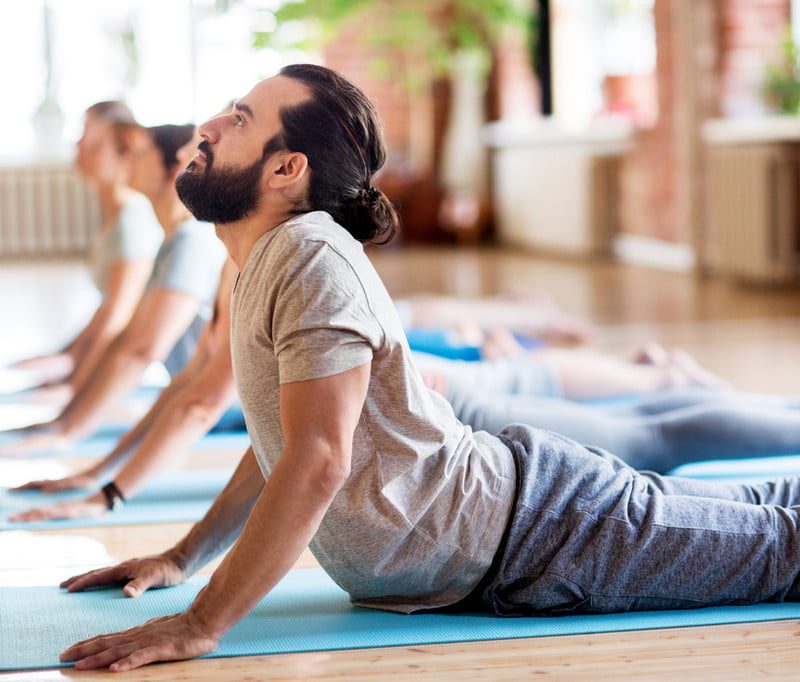 Man doing yoga on a yoga mat.