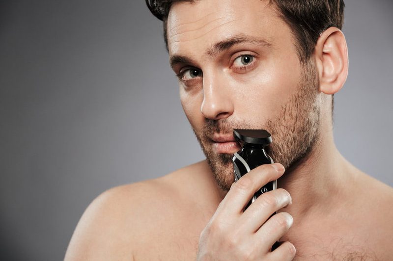Man using electric razor