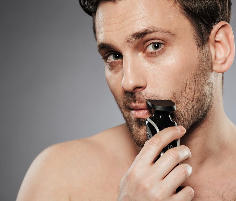 Man using electric razor