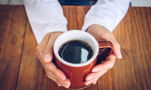 Hands holding cup of coffee